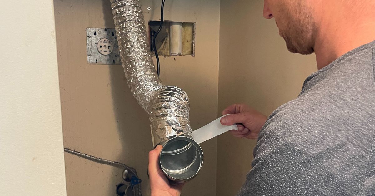 Men Cleaning Dryer Vent
