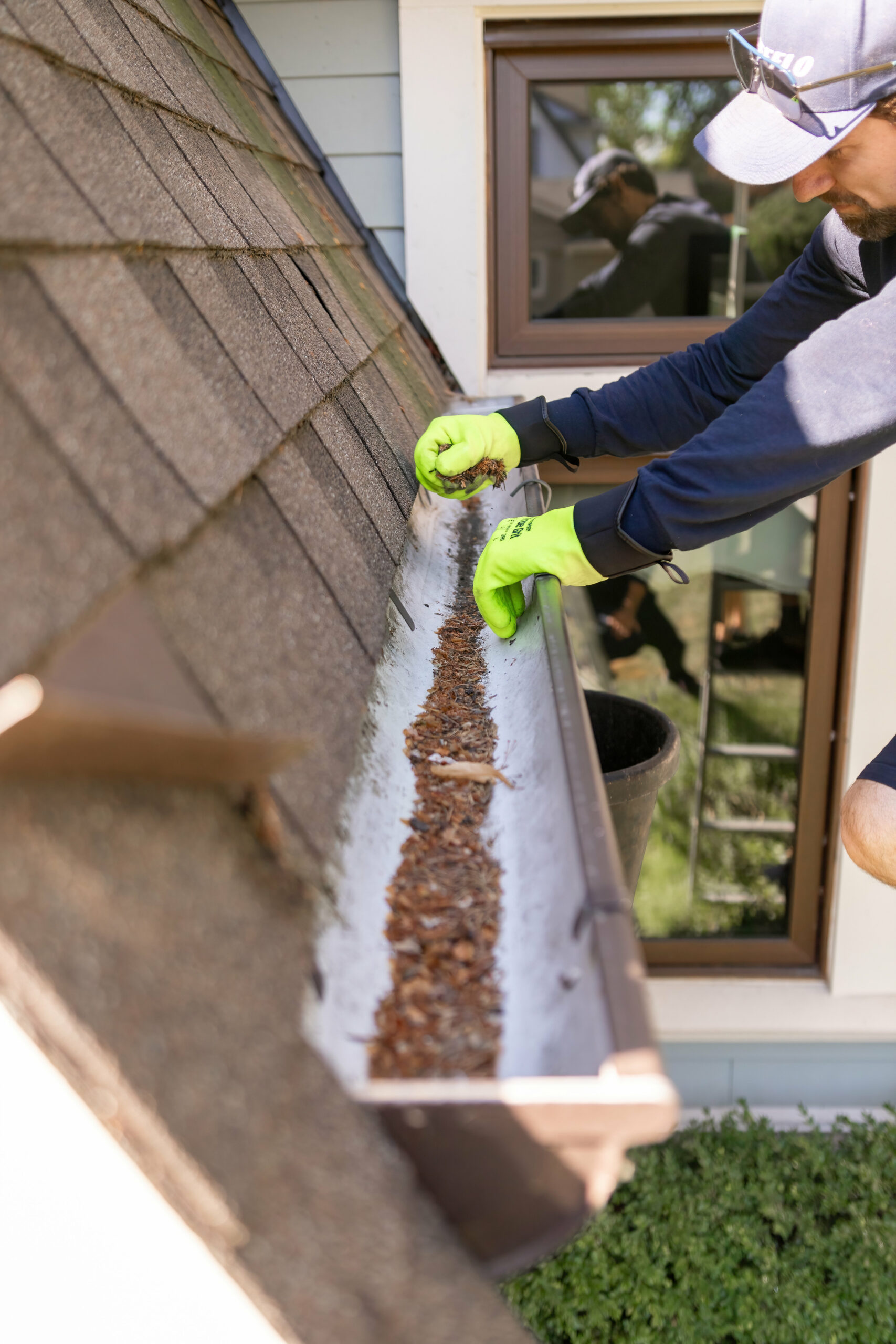 Man Cleaning Gutter